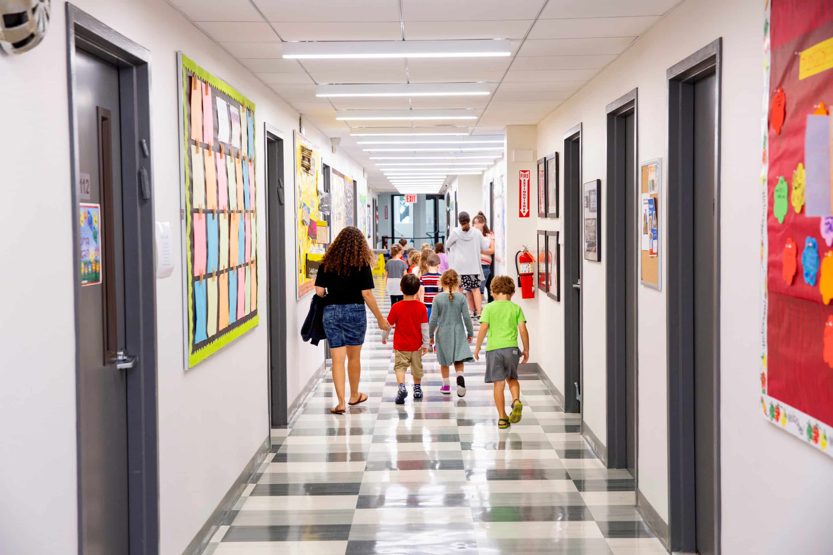 Children walking down school hallway School corridor